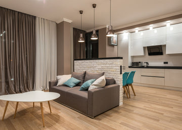 modern open concept living room dining room kitchen in warm gray with blue accents min