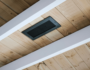 kul grilles Black Monolith ceiling vent on wood panelled ceiling