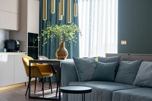 kul plates anodized matte gold switch plate in modern blue living space with gold chandelier 1