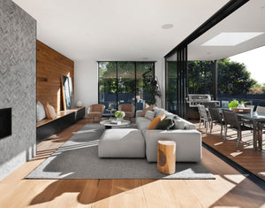 modern luxury living room with multifold doors to patio