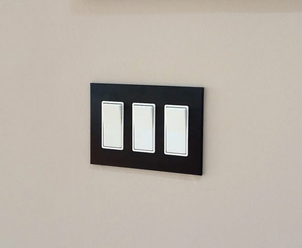 anodized matte black 3gang light switch cover from kul grilles on beige wall